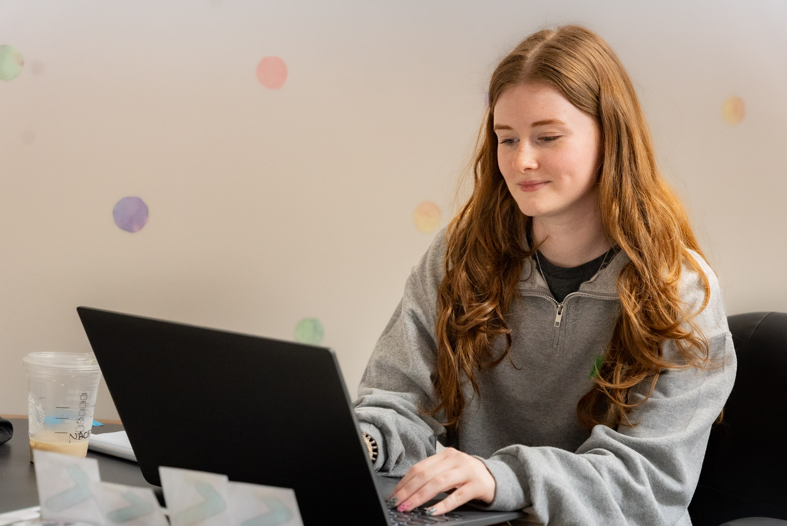 Staff member working on a laptop at a desk