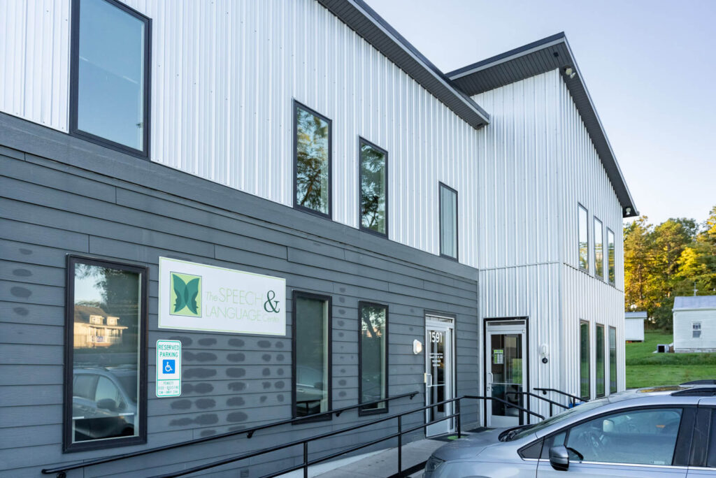 Exterior of a gray building with The Speech & Language Center sign