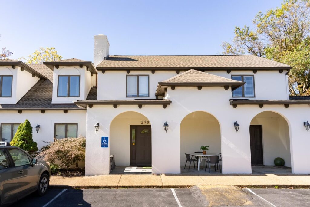 White stucco office building with arched entrances